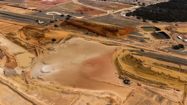 Aerial view of industrial mining site with red sand earthworks and pools of water showing complex patterns Kalbarri Western Australia Australia. Aerial view of industrial mining site with red sand earthworks and pools of water showing complex patterns Kalbarri Western Australia Australia.