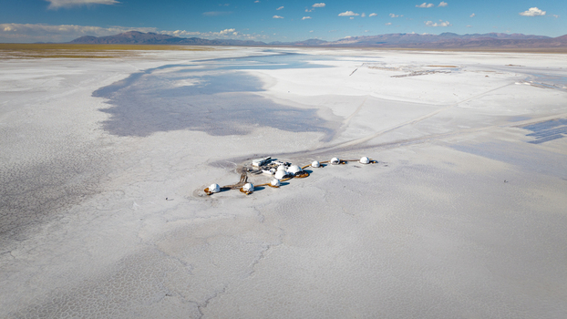 Aerial view of the white salt flats of Salinas Grandes with a cluster of dome structures in the vast landscape of La Poma Department Salta Province Argentina. Aerial view of the white salt flats of Salinas Grandes with a cluster of dome structures in the vast landscape of La Poma Department Salta Province Argentina.