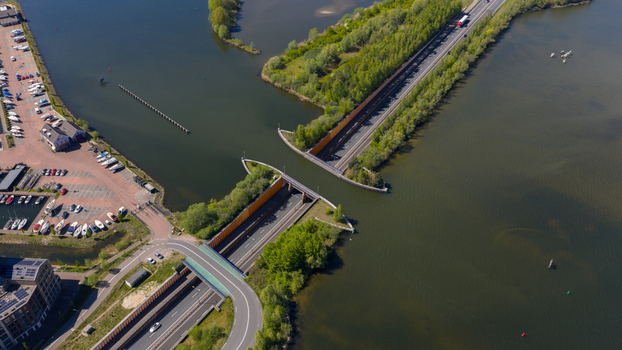 Aerial view of Aquaduct Veluwemeer with cars driving through the tunnel under the water and a nearby marina in Harderwijk Gelderland Netherlands. Aerial view of Aquaduct Veluwemeer with cars driving through the tunnel under the water and a nearby marina in Harderwijk Gelderland Netherlands.