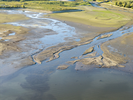 Aerial view of Lake Czorsztynskie with low water levels revealing intricate mudflats and river channels in Nowy Targ County Lesser Poland Voivode Poland. Aerial view of Lake Czorsztynskie with low water levels revealing intricate mudflats and river channels in Nowy Targ County Lesser Poland Voivode Poland.