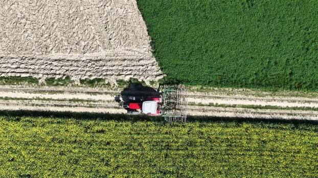 Aerial view of tractor on a farm land France.