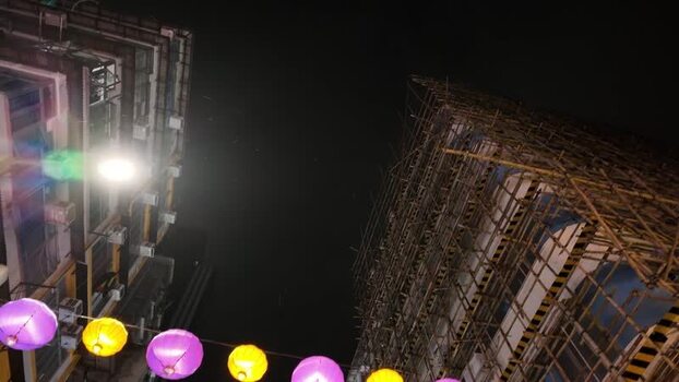 View of bamboo scaffolding and lanterns at night Hong Kong.