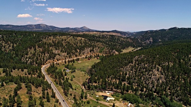 Aerial view of Barker Meadow Reservoir surrounded by dense pine forests and winding mountain roads in Boulder County Colorado United States. Aerial view of Barker Meadow Reservoir surrounded by dense pine forests and winding mountain roads in Boulder County Colorado United States.