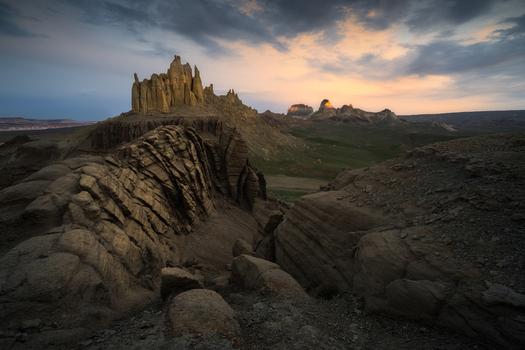 View of dramatic rock formations and rugged desert landscape under a sunset sky in Mangistau Mangystau Region Kazakhstan. View of dramatic rock formations and rugged desert landscape under a sunset sky in Mangistau Mangystau Region Kazakhstan.