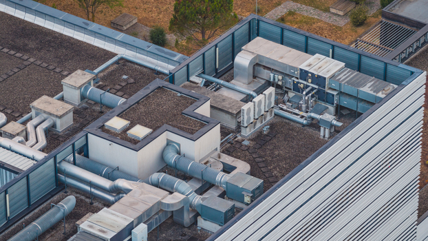 Aerial view of rooftop HVAC infrastructure featuring industrial ventilation ducts and cooling equipment on a modern building in Valence Auvergne Rhone Alpes France.