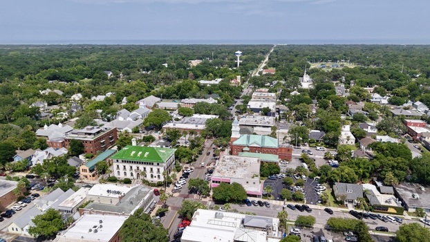 Aerial view of the vibrant downtown area with historic buildings lush green trees and a distant water tower Fernandina Beach Florida United States. Aerial view of the vibrant downtown area with historic buildings lush green trees and a distant water tower Fernandina Beach Florida United States.