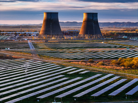 Trino Italy 30 March 2026 Aerial view of solar panels stretching towards colossal cooling towers a juxtaposition of modern energy and industrial might under a serene sky. Trino Italy 30 March 2026 Aerial view of solar panels stretching towards colossal cooling towers a juxtaposition of modern energy and industrial might under a serene sky.