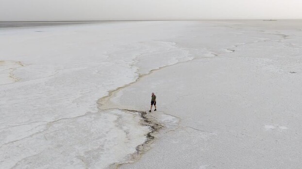 Aerial view of a person walking on the Danakil Desert salt flats Ethiopia.