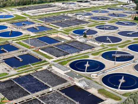 Aerial view of the Impianto depurazione wastewater treatment plant with circular sedimentation tanks and rectangular basins in Castiglione Torinese Piedmont Italy.