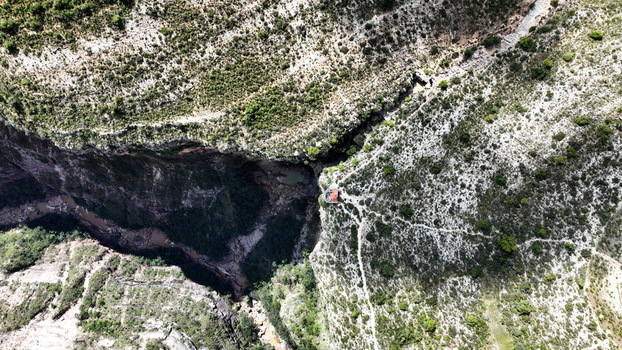 Aerial view of El Vergel canyon featuring steep rocky cliffs lush vegetation and a winding river flowing through the deep gorge in Torotoro Potosi Department Bolivia. Aerial view of El Vergel canyon featuring steep rocky cliffs lush vegetation and a winding river flowing through the deep gorge in Torotoro Potosi Department Bolivia.