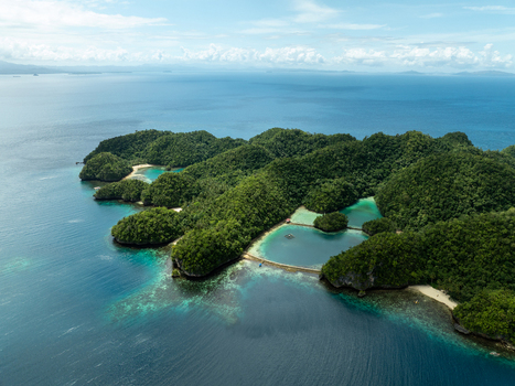Aerial view of Bucas Grande islands featuring lush green hills turquoise lagoons and clear blue waters under a bright sky in Siargao Philippines. Aerial view of Bucas Grande islands featuring lush green hills turquoise lagoons and clear blue waters under a bright sky in Siargao Philippines.