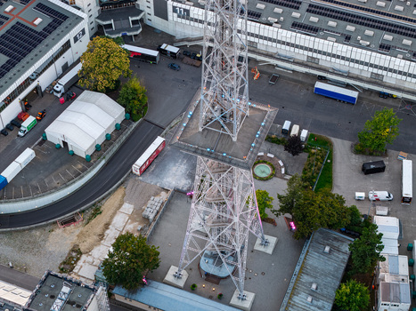 Aerial view of the iconic radio tower at the ICC Berlin featuring distinctive brutalist architecture surrounded by exhibition grounds and industrial infrastructure in Berlin Berlin Germany. Aerial view of the iconic radio tower at the ICC Berlin featuring distinctive brutalist architecture surrounded by exhibition grounds and industrial infrastructure in Berlin Berlin Germany.