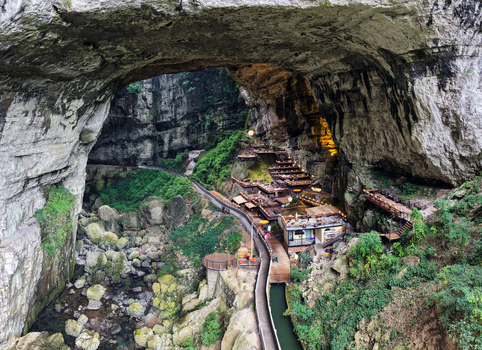 Guiyang China 24 June 2026 Aerial view of the karst cave landscape in Xiuwen County featuring wooden walkways tiered platforms and lush greenery nestled within a massive natural limestone arch. Guiyang China 24 June 2026 Aerial view of the karst cave landscape in Xiuwen County featuring wooden walkways tiered platforms and lush greenery nestled within a massive natural limestone arch.
