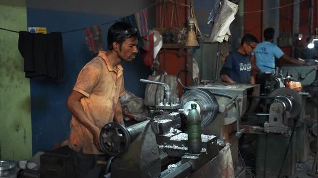 View of a worker operating a lathe machine in Bogura Bangladesh.