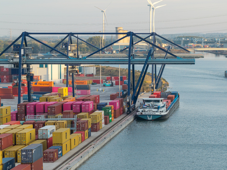 Genk Belgium 27 August 2026 Aerial view of the Haven Genk container terminal with colorful shipping containers a docked cargo ship and large gantry cranes. Genk Belgium 27 August 2026 Aerial view of the Haven Genk container terminal with colorful shipping containers a docked cargo ship and large gantry cranes.
