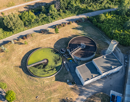 Aerial view of circular clarifier tanks at a wastewater treatment plant in Le Pouzin Auvergne Rhone Alpes France.