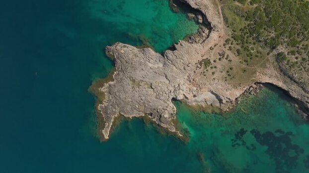 Aerial view of Plemmirio rocky coastline and turquoise waters Italy.