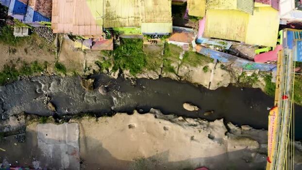 Aerial view of a narrow river and colorful houses Indonesia.