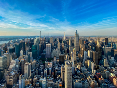 New York New York United States 09 August 2021 Aerial view of the dense Manhattan skyline with iconic skyscrapers and glass towers under a clear blue sky.