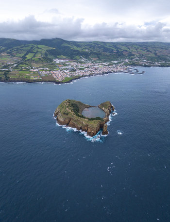 Aerial view of Ilheu de Vila Franca do Campo a volcanic islet with a central lagoon surrounded by the Atlantic Ocean near the coast of Sao Pedro Acores Portugal. Aerial view of Ilheu de Vila Franca do Campo a volcanic islet with a central lagoon surrounded by the Atlantic Ocean near the coast of Sao Pedro Acores Portugal.