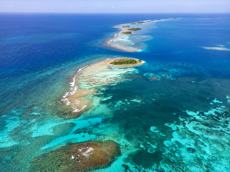 Aerial view of the stunning coral reefs and tropical cays surrounded by turquoise Caribbean waters in Guanaja Bay Islands Department Honduras. Aerial view of the stunning coral reefs and tropical cays surrounded by turquoise Caribbean waters in Guanaja Bay Islands Department Honduras.