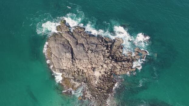 Aerial view of a rocky island in the turquoise ocean India. Aerial view of a rocky island in the turquoise ocean India.