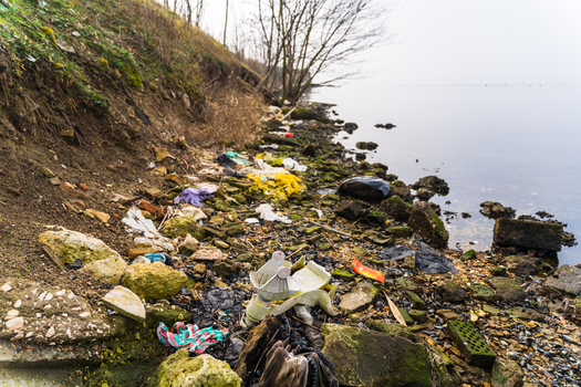 View of plastic waste and debris scattered along the rocky shoreline of Lake Varna Varna Bulgaria. View of plastic waste and debris scattered along the rocky shoreline of Lake Varna Varna Bulgaria.