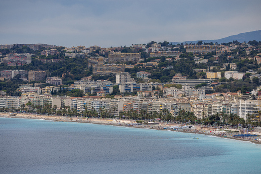 Aerial view of the coastline and urban architecture of Nice featuring the turquoise Mediterranean Sea and dense buildings. Nice Provence Alpes Cote d Azur France. Aerial view of the coastline and urban architecture of Nice featuring the turquoise Mediterranean Sea and dense buildings. Nice Provence Alpes Cote d Azur France.