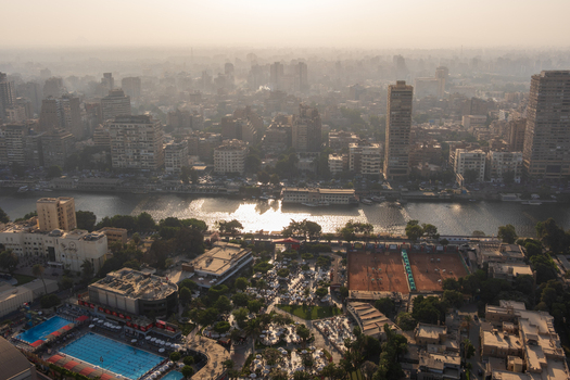 View of the city s hazy sunlight dances on the Nile River embraced by buildings pools and greenery creating a contrast Zamalek Cairo Governorate Egypt. View of the city s hazy sunlight dances on the Nile River embraced by buildings pools and greenery creating a contrast Zamalek Cairo Governorate Egypt.