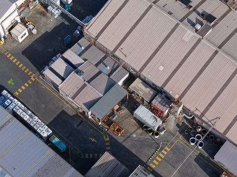 Melbourne Australia 22 September 2026 Aerial view of industrial factories in Kilsyth featuring metal rooftops loading bays and storage containers in a commercial zone. Melbourne Australia 22 September 2026 Aerial view of industrial factories in Kilsyth featuring metal rooftops loading bays and storage containers in a commercial zone.