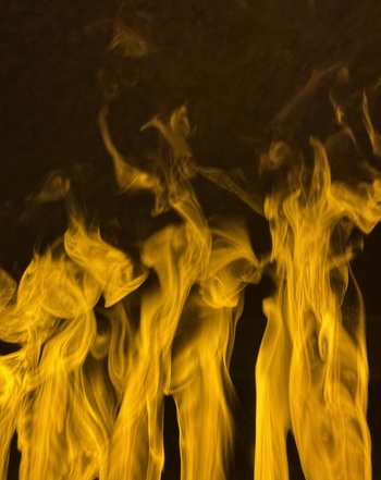 View of flickering golden flames rising against a dark background in a spa setting in Banya Blagoevgrad Province Bulgaria.