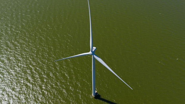 Aerial view of Windpark Fryslan offshore wind turbine standing in the water in Breezanddijk Friesland Netherlands. Aerial view of Windpark Fryslan offshore wind turbine standing in the water in Breezanddijk Friesland Netherlands.