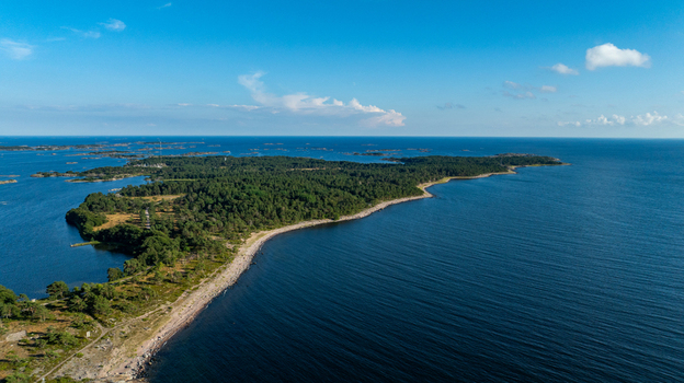 Aerial view of Oro Fortress Island surrounded by the Baltic Sea with dense pine forests rocky coastlines and clear blue skies in Oro Varsinais Suomi Finland. Aerial view of Oro Fortress Island surrounded by the Baltic Sea with dense pine forests rocky coastlines and clear blue skies in Oro Varsinais Suomi Finland.