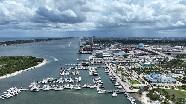 Aerial view of boats docked in the marina contrasting with the city skyline under a cloudy sky West Palm Beach Florida United States.