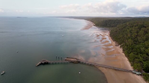 Aerial view of Kingfisher Bay Resort pier and coastline Australia.
