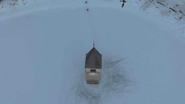 Aerial view of the historic bell tower in Graun im Vinschgau Italy. Aerial view of the historic bell tower in Graun im Vinschgau Italy.