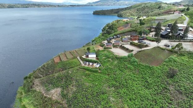 Aerial view of Alahan Panjang lake and green hills Indonesia. Aerial view of Alahan Panjang lake and green hills Indonesia.