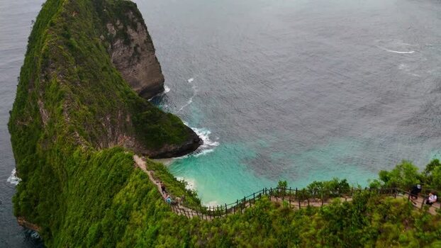 Aerial view of Kelingking Beach with tourists on the cliff path Indonesia. Aerial view of Kelingking Beach with tourists on the cliff path Indonesia.