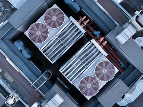 Aerial view of industrial cooling fans on a data center rooftop with metal pipes and ventilation systems in Krakow Lesser Poland Voivode Poland. Aerial view of industrial cooling fans on a data center rooftop with metal pipes and ventilation systems in Krakow Lesser Poland Voivode Poland.