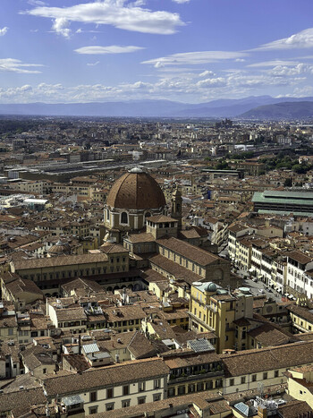 Aerial view of the Chapel of the Princes and the Basilica of San Lorenzo surrounded by historic terracotta rooftops and urban architecture in Florence Italy. Aerial view of the Chapel of the Princes and the Basilica of San Lorenzo surrounded by historic terracotta rooftops and urban architecture in Florence Italy.