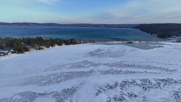 Aerial view of Sleeping Bear Dunes and frozen lake United States.