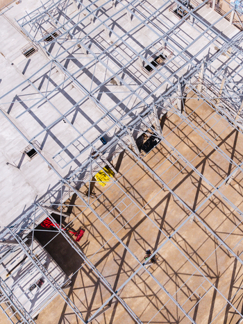 Aerial view of a steel frame structure under construction with metal beams and geometric shadows at a building site in Riga Latvia. Aerial view of a steel frame structure under construction with metal beams and geometric shadows at a building site in Riga Latvia.