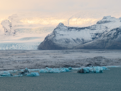 Aerial view of Breidamerkurjokull glacier with floating icebergs in the glacial lagoon and snow covered mountains in Sveitarfelagid Hornafjordur Iceland. Aerial view of Breidamerkurjokull glacier with floating icebergs in the glacial lagoon and snow covered mountains in Sveitarfelagid Hornafjordur Iceland.