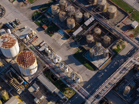 Aerial view of an industrial facility featuring numerous large storage tanks complex pipeline networks and paved access roads in Nera Montoro Umbria Italy. Aerial view of an industrial facility featuring numerous large storage tanks complex pipeline networks and paved access roads in Nera Montoro Umbria Italy.