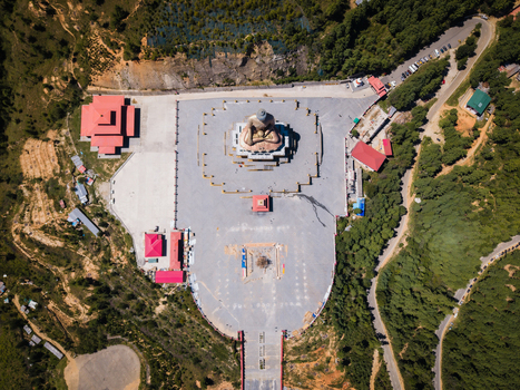 Aerial view of the Great Buddha Dordenma statue standing majestically amidst the expansive plaza a beacon of serenity against Bhutan s vivid landscape Thimphu Bhutan.