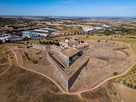 Elvas Portugal 10 September 2026 Aerial view of Forte de Santa Luzia a historic star shaped fortification surrounded by dry fields and the town landscape under a blue sky. Elvas Portugal 10 September 2026 Aerial view of Forte de Santa Luzia a historic star shaped fortification surrounded by dry fields and the town landscape under a blue sky.