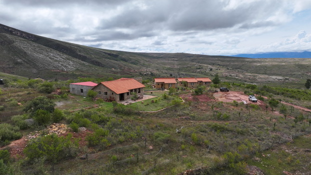 Aerial view of stone buildings with terracotta roofs nestled in the rugged landscape of the Andes mountains under a cloudy sky in Torotoro Potosi Department Bolivia. Aerial view of stone buildings with terracotta roofs nestled in the rugged landscape of the Andes mountains under a cloudy sky in Torotoro Potosi Department Bolivia.