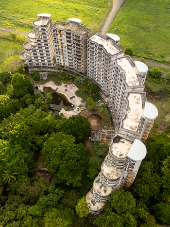 Aerial view of the abandoned Sonesta One Resort building complex surrounded by lush tropical forest and green fields in Jaco Puntarenas Costa Rica. Aerial view of the abandoned Sonesta One Resort building complex surrounded by lush tropical forest and green fields in Jaco Puntarenas Costa Rica.
