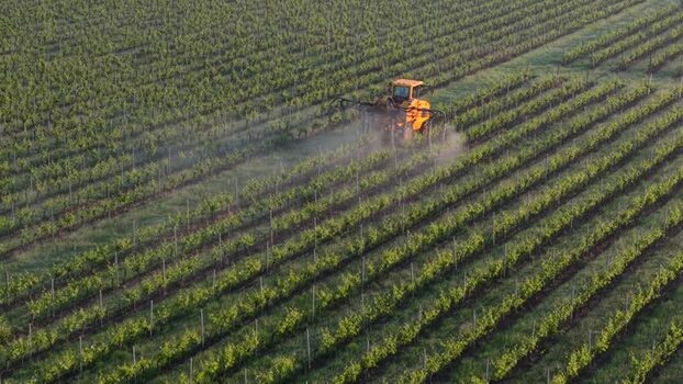 Aerial view of tractor in vineyard in Targon France.