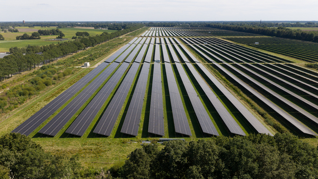 Aerial view of Zonnepark Pekela a large scale solar farm with rows of photovoltaic panels arranged in a rural landscape with surrounding trees in Oude Pekela Groningen Netherlands. Aerial view of Zonnepark Pekela a large scale solar farm with rows of photovoltaic panels arranged in a rural landscape with surrounding trees in Oude Pekela Groningen Netherlands.